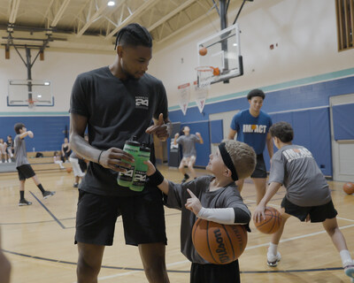 Blake Wesley, guard for the San Antonio Spurs, gives a few pointers to a young player on the game and performance nutrition during a Herbalife-hosted youth basketball clinic in San Antonio.