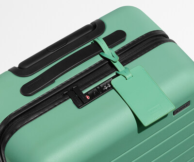 Refreshed luggage tag, now color matched to the exterior shell, featuring a slimmer profile and reduced hardware for a modern, clean look.