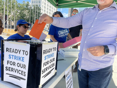 San Jose city worker submits a ballot in the union strike authorization vote outside City Hall.