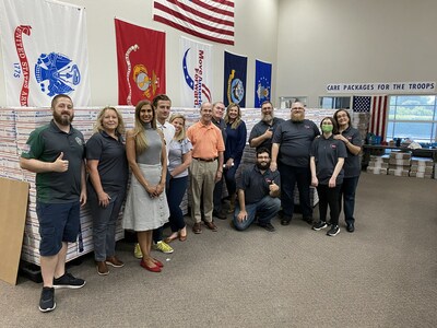 Senator Roger Niello (center, orange shirt) pays a visit to representatives from Suburban Propane and Move America Forward as they joined forces to pack more than 200 care packages for deployed soldiers, serving more than 1,000 troops. The effort is part of Suburban Propane’s SuburbanCares initiative in communities across the nation. (Photo courtesy of Suburban Propane).