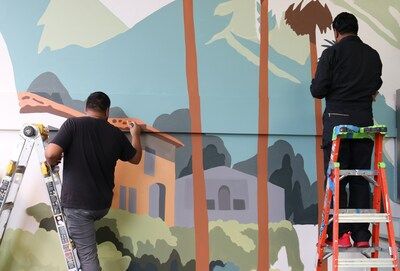 From left, artists Juan Navarro and Robert Cervantes work to complete a mural at IEHP headquarters in Rancho Cucamonga as part of an in-progress re-branding campaign. Navarro will complete six murals for the not-for-profit health organization. Locations are in the works.