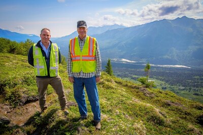 Figure 1 U.S. GoldMining CEO Tim Smith (left) and Alaska Governor Mike Dunleavy (right) standing on the Whistler Gold-Copper Project, overlooking the camp site, airstrip and Skwentna River valley. August 3, 2023. (CNW Group/U.S. GoldMining Inc.)