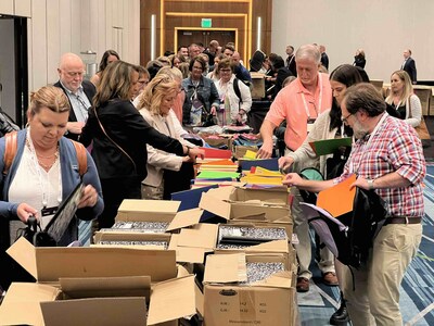 Ignite! attendees working together to assemble backpacks during the event’s volunteer activity