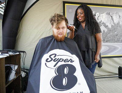 Celebrity hairstylist Kim Kimble doles out a fresh new look for driver Chase Brinwall of Fargo N.D. during a pit stop at the brand’s pop-up salon on Tuesday, August 8, 2023 in Summit, S.D. (Craig Lassig/AP Images for Super 8 ® by Wyndham)