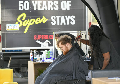 Kicking off celebrations for Super 8 by Wyndham’s upcoming 50th anniversary, celebrity hairstylist Kim Kimble helps driver Chase Brinwall of Fargo N.D. get a fresh new look during a pit stop at the brand’s pop-up salon on Tuesday, August 8, 2023 in Summit, S.D. (Craig Lassig/AP Images for Super 8 ® by Wyndham)