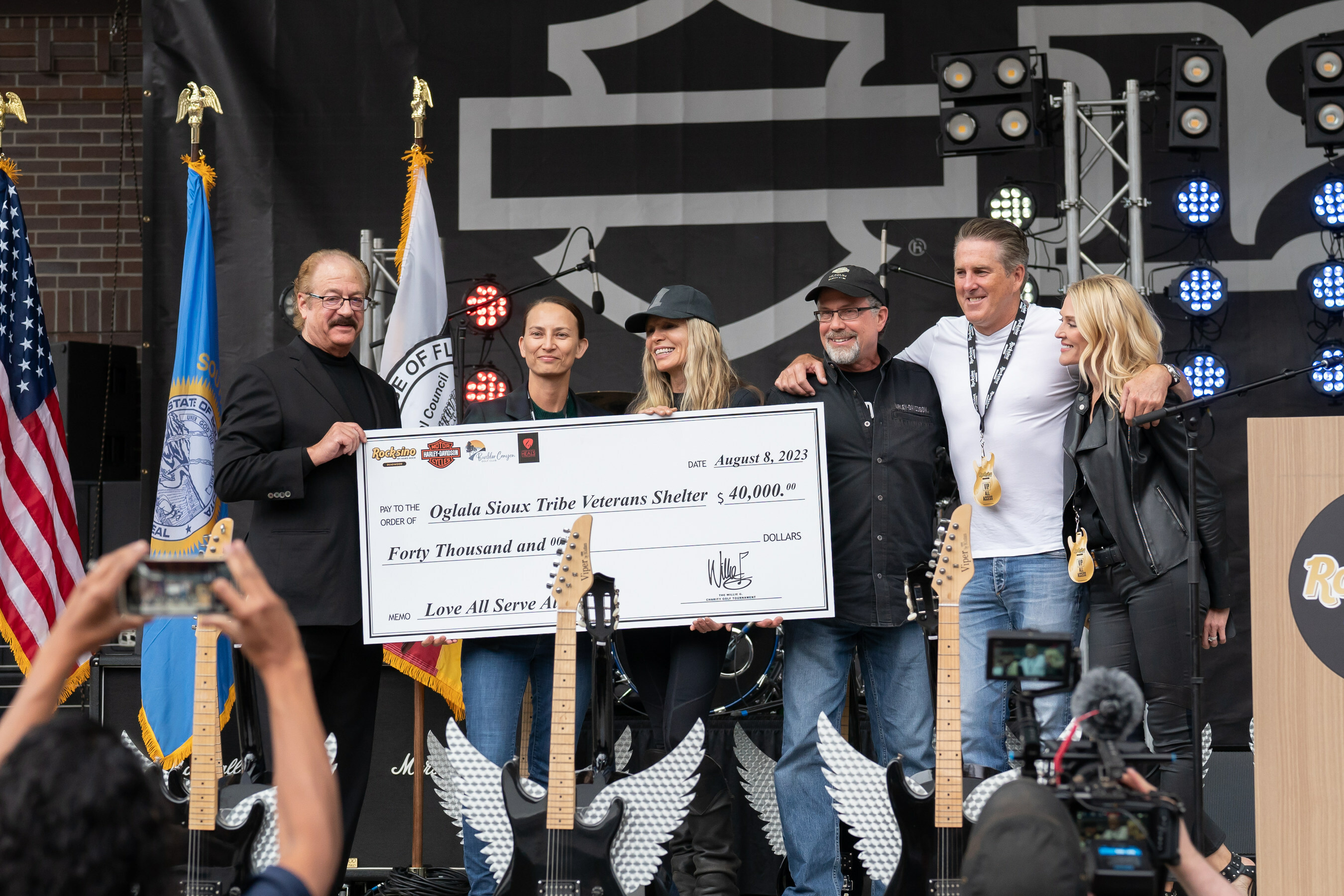 Hard Rock International COO Jon Lucas, Oglala Sioux Tribe Vice President Dr. Alicia Mousseau, Karen and Bill Davidson of the Harley-Davidson Motor Co., and Marlin and Camille McMakin of the Boulder Canyon Golf Club accepting a $40,000 donation.