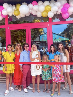 Owner Leigh Sewell cuts opening day ribbon