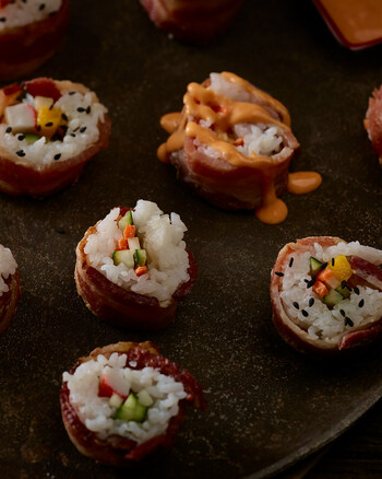 Wrapping bacon around anything instantly elevates the flavor profile of any dish, like this bacon-wrapped sushi.