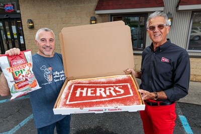 Celebrating triumph in taste, Ed Herr, Herr's Chairman, and Joe Corropolese, owner of Corropolese Italian Bakery & Deli, are pictured celebrating the news that Tomato Pie-flavored chips have been crowned winners of Herr’s 2023 'Flavored by Philly' contest. Fusing heritage and innovation, these chips encapsulate Philadelphia's cherished flavors, embodying community support and Herr’s dedication to small businesses crafting resonant taste experiences. Learn more at herrs.com.