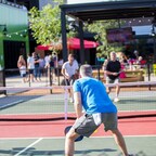 Chicken N Pickle is the original indoor/outdoor “eatertainment” complex with a casual, chef-driven restaurant, sports bar, pickleball courts and a variety of yard games.