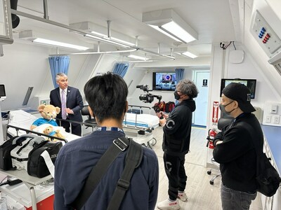 Dr. Hunter Cherwek, Vice President, Clinical Services and Technologies, Orbis International, shows a media crew around the Orbis Flying Eye Hospital while on location in Osaka, Japan in April 2023.