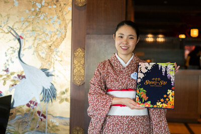 Mizuki, a guest service cast member and cultural representative from Japan, presents the Shiki-Sai menu.