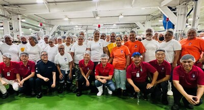 President & CEO of StarKist Co., Chae-Ung Um (kneeling, fourth from far right) surrounded by the StarKist Samoa management team and the Packing Room Day Shift employees on Wednesday, August 30, 2023.