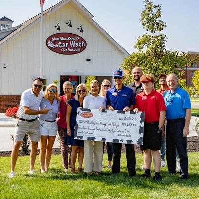 The Express Wash Concepts team presenting Healthy New Albany with $14,658.69 to celebrate the opening of the newest Moo Moo Express in New Albany.