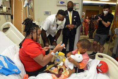 Hall of Fame football player Calvin "Megatron" Johnson Jr. delivers a My Special Aflac Duck to a patient at The Aflac Cancer and Blood Disorders Center at Children's Healthcare of Atlanta as part of Aflac's Kickoff for a Cause football game tonight in Atlanta.