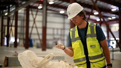 American Battery Technology Company's Kris Gustafson, director of technical programs, inspects lithium-bearing claystone from the company's Tonopah Flats Lithium resource in Nevada where the ABTC first-of-kind, commercial-scale lithium hydroxide manufacturing facility, supported by a U.S. Department of Energy grant award, is planned to be located.