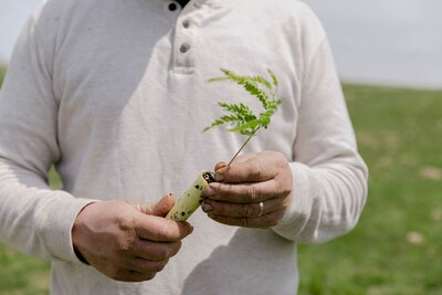 Organic Valley farmer-member Tucker Gretebeck, nurturing the future with a sapling for his agroforestry project, as part of Organic Valley's commitment to climate-friendly dairy.