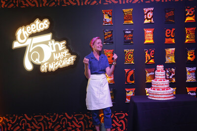 Milk Bar owner Christina Tosi cuts into the one-of-a-kind Cheetos Milk Bar birthday cake that is now available nationwide in honor of the snack brand’s 75th birthday