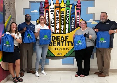 Acceptance Insurance team members (from left) Anthony Clarke, Kwani Cornell-Young, Jackie Kosco, and Anthony Jones present Kim Krause, principal of the Indiana School for the Deaf, with school supplies for the upcoming year.