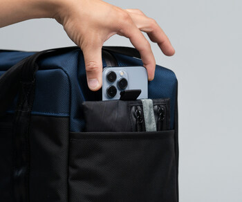 iPhone EDC Pouch keeps Phone 15 and pocket contents organized within a large bag pocket