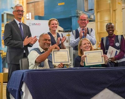 Pyxus Agriculture Limited (Malawi) Managing Director Ron Ngwira (bottom left) and USAID Malawi Mission Director Pamela Fessenden (bottom right) during the recent signing ceremony at PAM's groundnut processing factory.