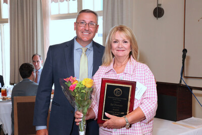 Gail Maniscalco receiving her award from the Professional Landmen’s Association of New Orleans.