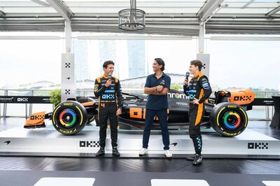 Lando Norris, Haider Rafique and Oscar Piastri revealing the MCL60 in Stealth Mode at an exclusive media event in Singapore at Lantern, Fullerton Bay Hotel (PRNewsfoto/OKX)