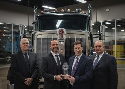 Receiving a Kenworth Gold Award in 2021, Palmer Trucks leadership stands with a Kenworth W990. Left to Right: Tom Kapitan - COO, Scott Nichols - CEO and Co-President, Jacob Nichols - CHRO and Co-President, John Nichols - Executive Chairman.