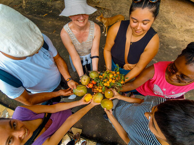 Volunteers from One Planet Group pick fruit from The Gambia