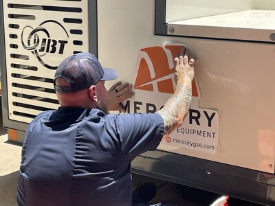 A Mercury Ground Support Equipment technician affixing the company's new logo decal on a JBT M-60 Air Conditioner/Heating Unit at Mercury's Saginaw, TX facility.