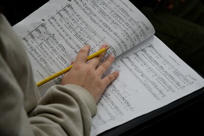 A GHC student studies music and takes notes in Dr. Balfour's class.