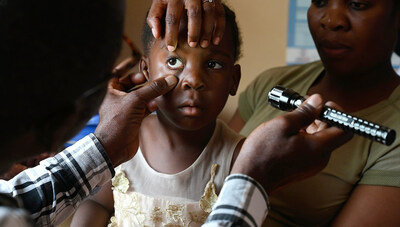 Kapiya, four years old, has an eye exam by an Orbis-trained community health worker in Mufulira, Zambia.