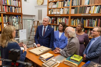 President of Lithuania, Dr. Gitanas Nausėda, and Lithuanian First Lady, Diana Nausėdienė with group reviewing the Marija Gimbutas Collection