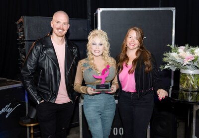 Susan G. Komen Tennessee State Executive Director, Joshua Daniel and Susan G. Komen Tennessee Development Director, April Douglas pose with Dolly Parton as they present her with the 2023 Promise Award. Photo credit: JB Rowland