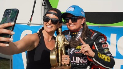 Sisters Courtney and 5-time NHRA Pro Stock Champion Erica Enders enjoy a moment in the winners circle.