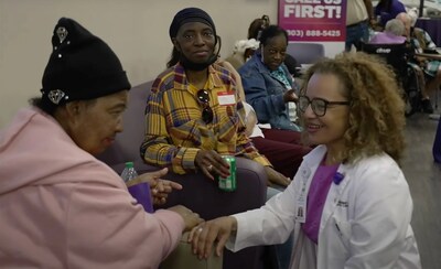 Meera Kelley, M.D., regional chief medical officer (pictured, far right), speaks with patients at Dedicated Senior Medical Center.