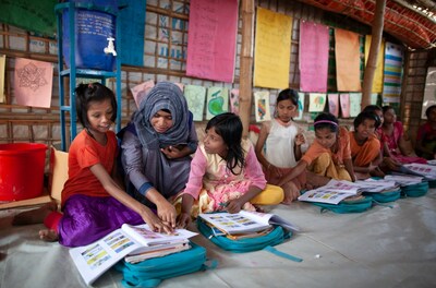 A teacher making a difference, Kamal Hossein spends some one-on-one time with Yasmina, a student in her class with a learning disability. Kamal encouraged Yasmina’s mother to make sure that Yasmina attended the learning center more frequently. © UNICEF/Bangladesh