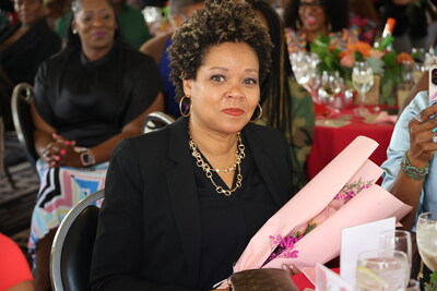 Leslie Williams Dunn, Malinda Willams' sister receiving flowers at the Arise And Shine brunch. Photo credit: Aliya Dyson