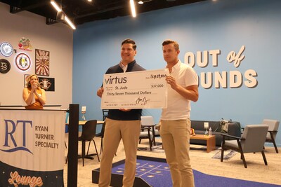 Andrew Gray, co-founder and CEO of Virtus, presents a check to David Ochoa, Area Executive Director - Mid-America at St. Jude Children's Research Hospital during the Virtus Open House.