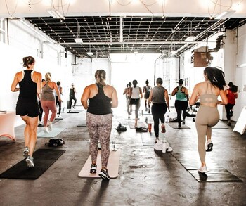 Enthusiastic participants breaking a sweat at the grand opening event of The GRIND Garage. Photo by-Erin/Sugar Plum Creative