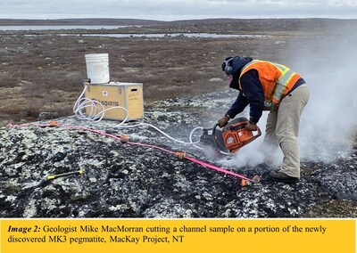Image 2: Geologist Mike MacMorran cutting a channel sample on a portion of the newly discovered MK3 pegmatite, MacKay Project, NT (CNW Group/North Arrow Minerals Inc.)