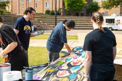 Students added their handprints to a piece of art after completing their service projects, signifying the great things that a community of servant-minded people can do to God's glory.
