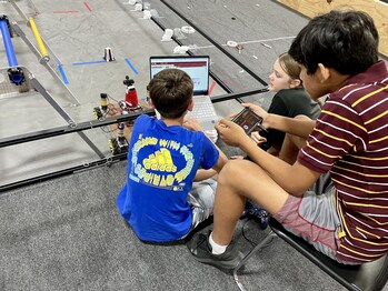 Members of Innovate Albion’s FIRST Tech Challenge (6th - 8th grade) team Sparks and Duct Tape work together to debug their code ahead of their first competition.