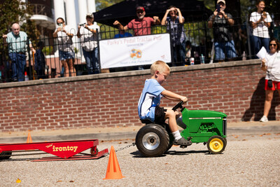 Children participate in the Porky's Pedal Tractor Pull sponsored by Noah's Ark Preschool.