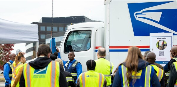 USPS Network Specialist Byron Stovall conducts training on how to properly use mirrors and check for blind spots during a truck safety rodeo demonstration.