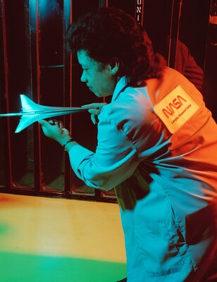 Dr. Christine Mann Darden holding a model of Mach II in the Unitary Tunnel at NASA’s Langley Research Center on Aug. 18, 1990. Darden is pictured in a lab coat with a NASA ‘worm’ logotype patch across her back. Credit: NASA / Carol Petrachenko Chapman