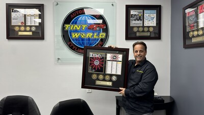 President and CEO of Tint World® Automotive Styling Centers™ Charles J. Bonfiglio shows off several of the awards his auto accessory and window tinting franchise has won in the past several years.