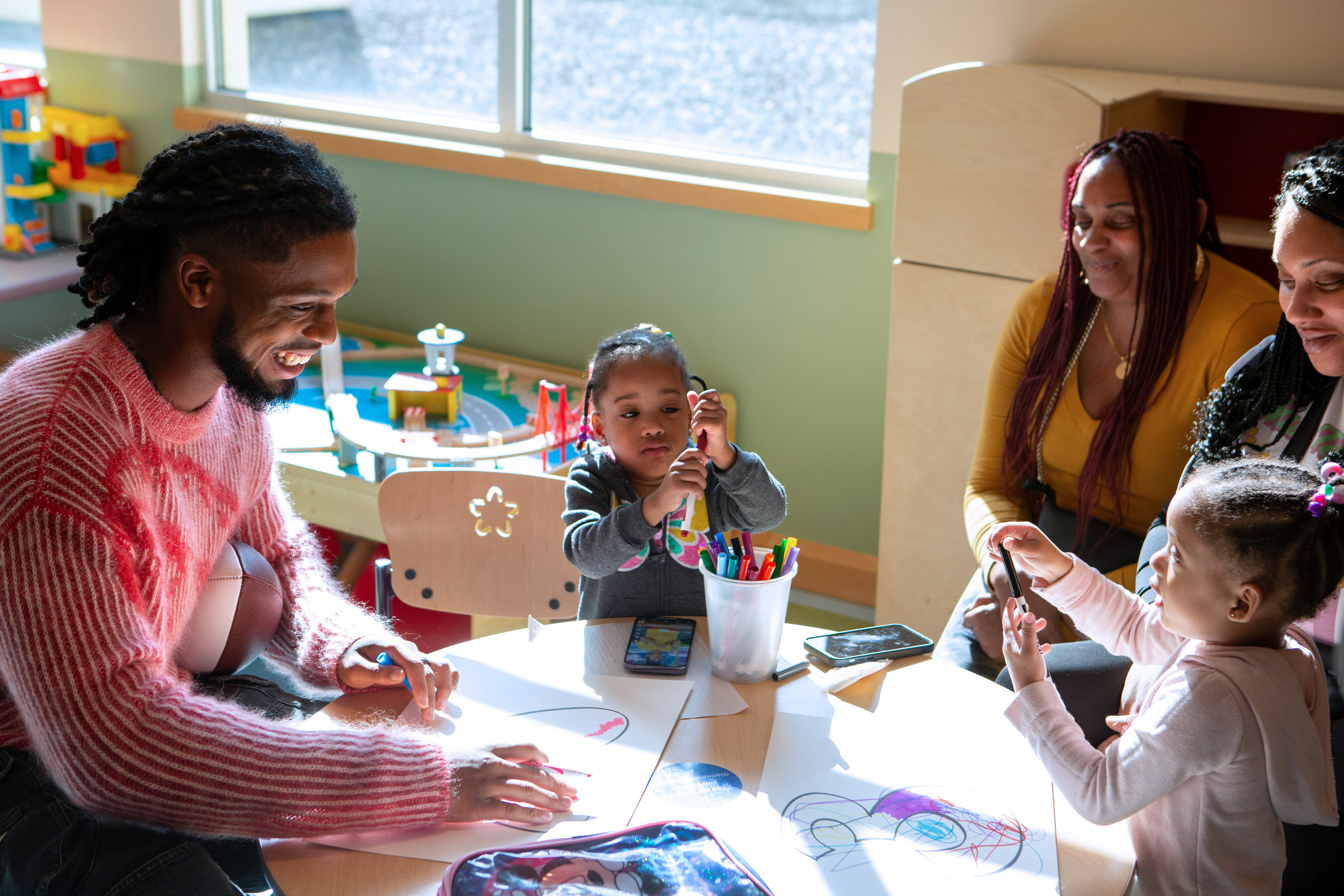 Damar Hamlin with children and families facing cardiovascular conditions.