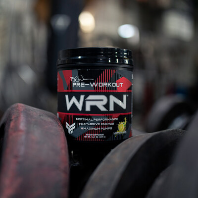 WRN Pre-Workout set amidst weight plates in gym.