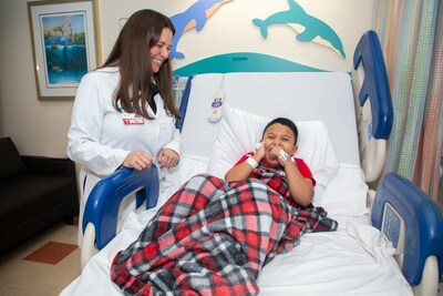 Jacob, 6, laughs with Migvis Monduy, MD, Medical Director, Neuromuscular and Movement Disorders Programs, as he awaits to receive the first FDA-approved gene therapy treatment for Duchenne Muscular Dystrophy on October 12, 2023 at Nicklaus Children's Hospital in Miami, Fl.